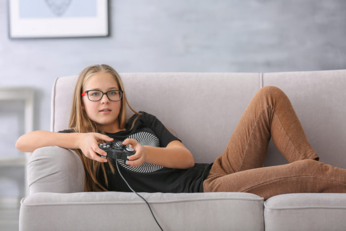 teenage girl playing with her playstation game