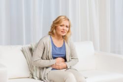 woman in pain holding stomach