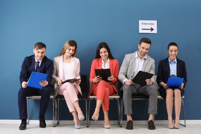 group of job applicants waiting for their interview and background check performed by HireRight