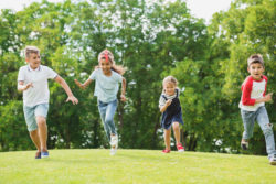 Kids play in a field.