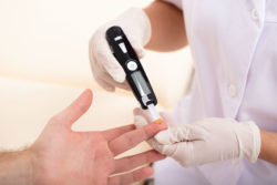 Close up of man getting blood sugar tested.