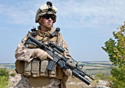 A Marine holds a rifle.