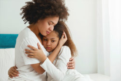 A mother comforts her daughter.