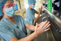 Two surgeons wash their hands.
