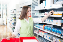 A woman is shopping in a drugstore.