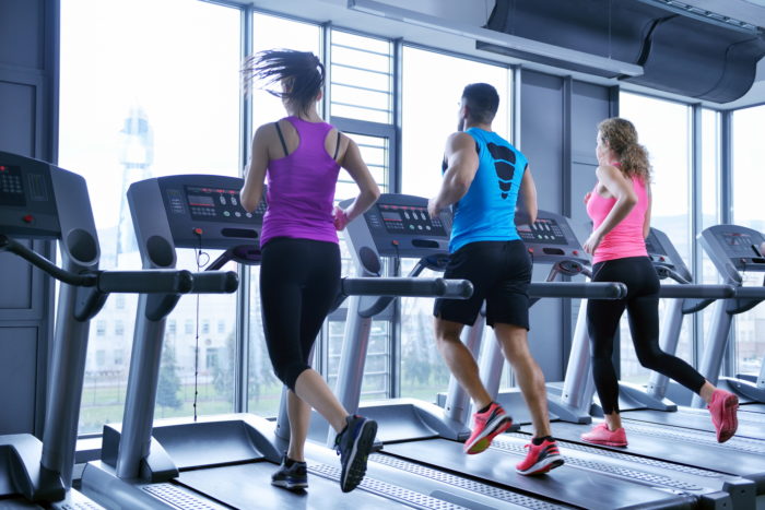 group of people running on treadmills at an Xperience Fitness gym