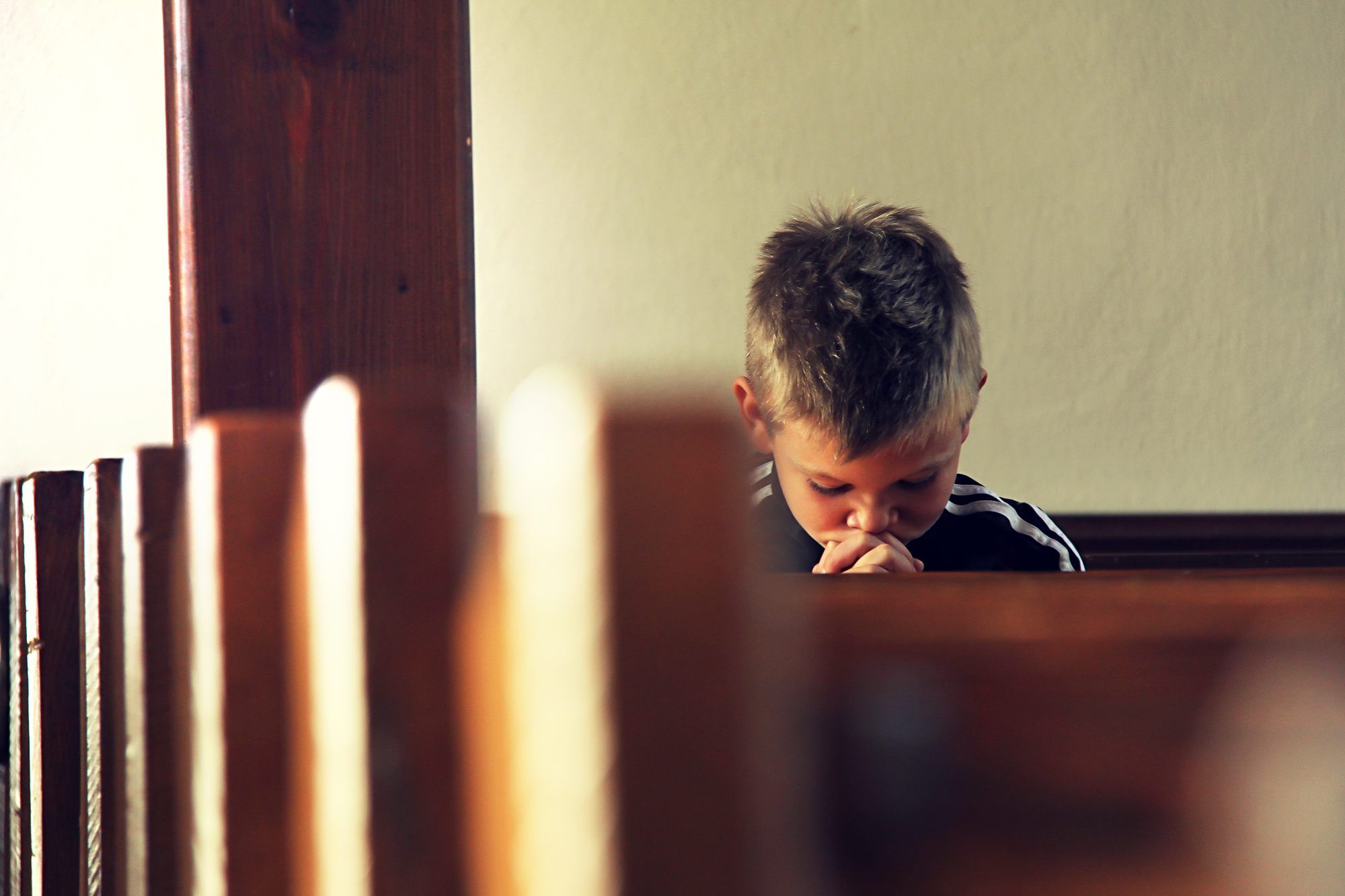 Boy praying in church