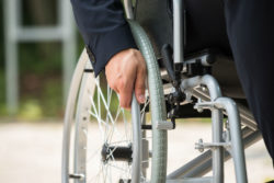 Close-up of man's hand on wheelchair
