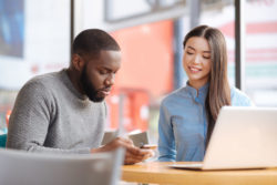 A couple looks at a smartphone.