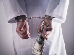 Doctor in handcuffs with cash