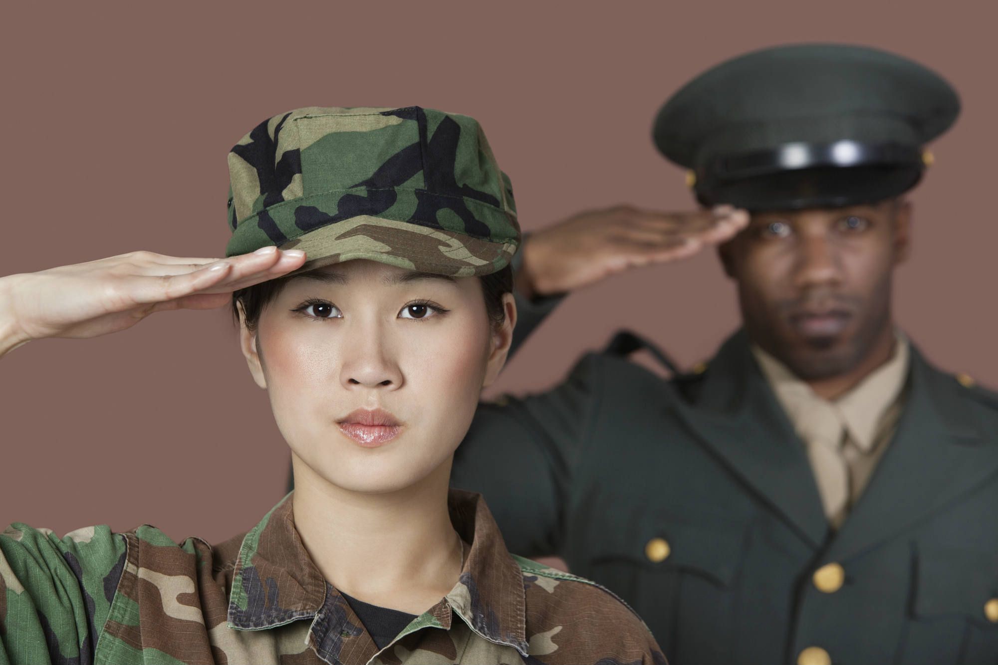 Female and male soldiers saluting
