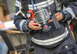 Firefighter holding mask