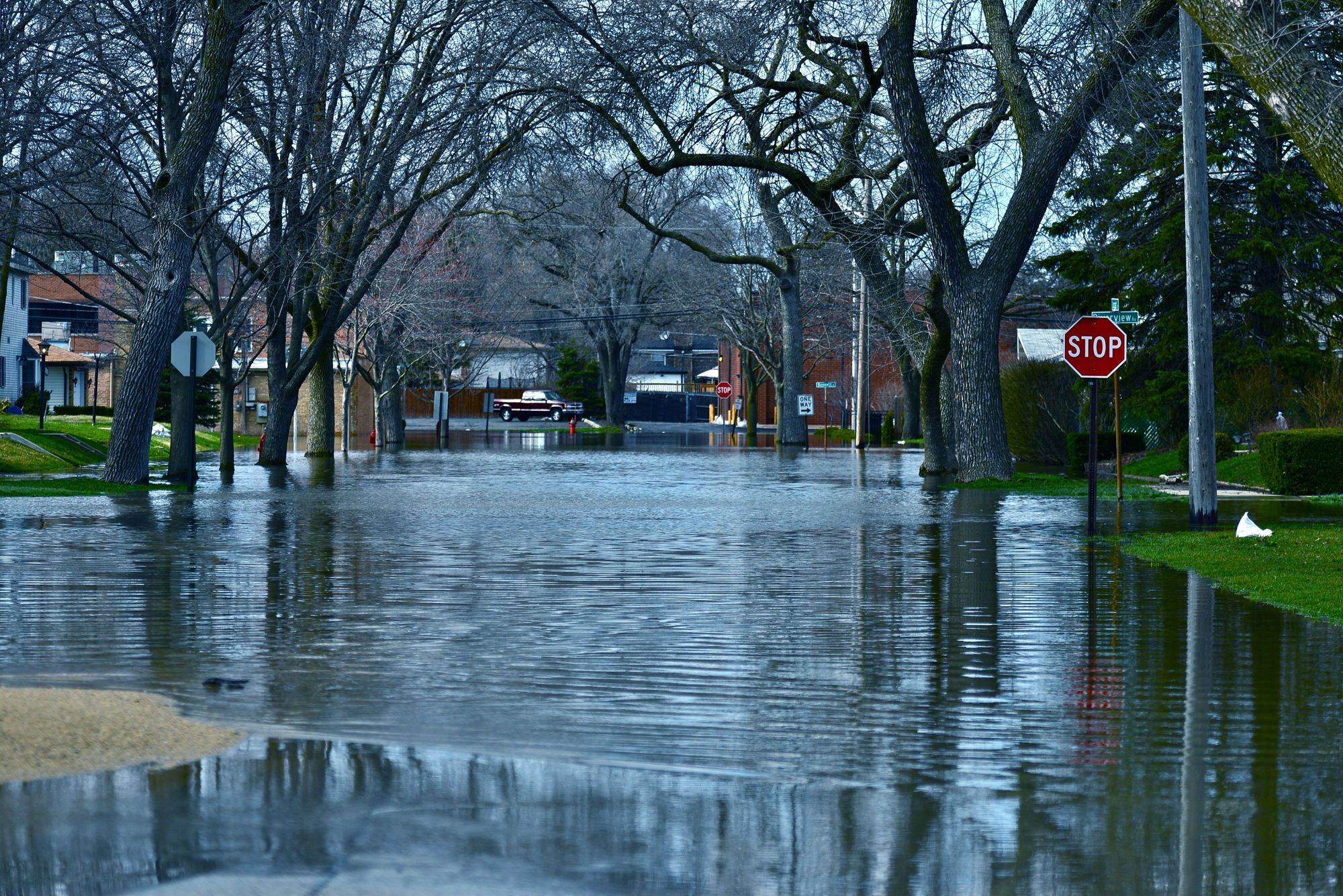 Flood waters fill a neighborhood street - sewage disposal system incident