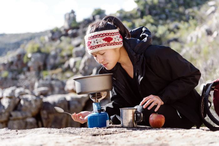 hiker cooking up wise long-term emergency food kit
