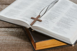 A bible lies open on a table.