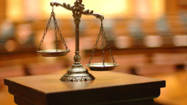 Scales sit on a lectern in a courtroom.