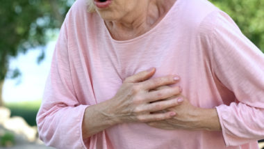 Close-up of a woman experiencing heart trouble.