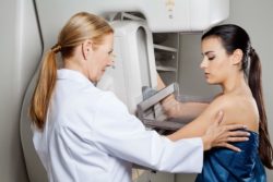 Woman getting a mammogram by a technician