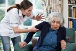Elderly woman and nurse, nursing home abuse