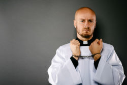 Handcuffed priest