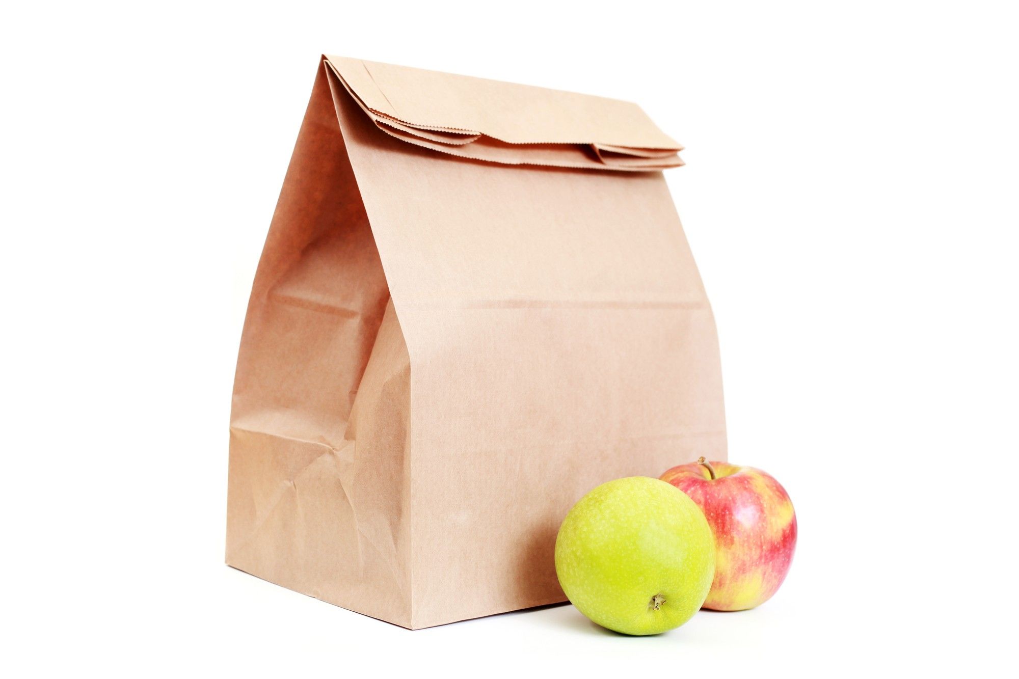 Lunch bag and apples on white