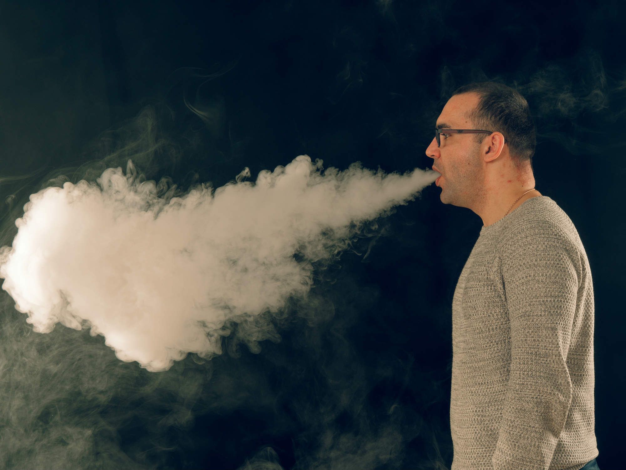 Man exhaling vape cloud