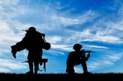 Silhouette of soldiers carrying wounded