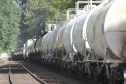 A train pulls tank cars carrying caustic soda.