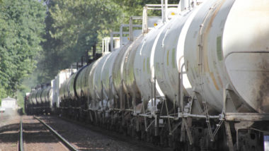 A train pulls tank cars carrying caustic soda.