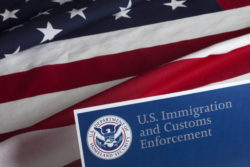 U.S. Immigration and Customs Enforcement over American flag