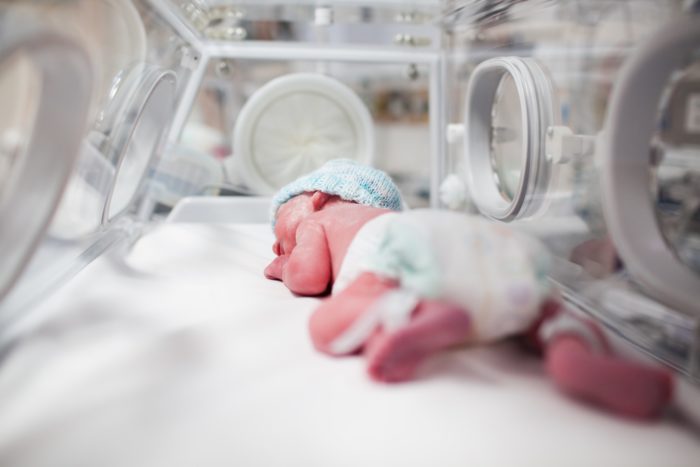 infant in incubator