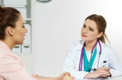 Concerned woman talking to doctor