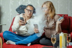 Couple vaping on the couch