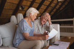 Elderly couple looking at surprise medical bills