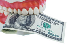 Model of tooth with hundred dollar bill