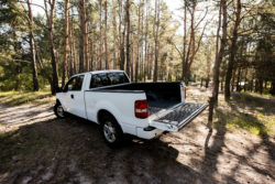 A white pickup truck in the woods