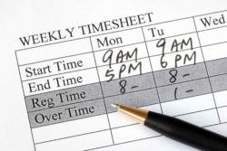 Weekly time sheet with pen