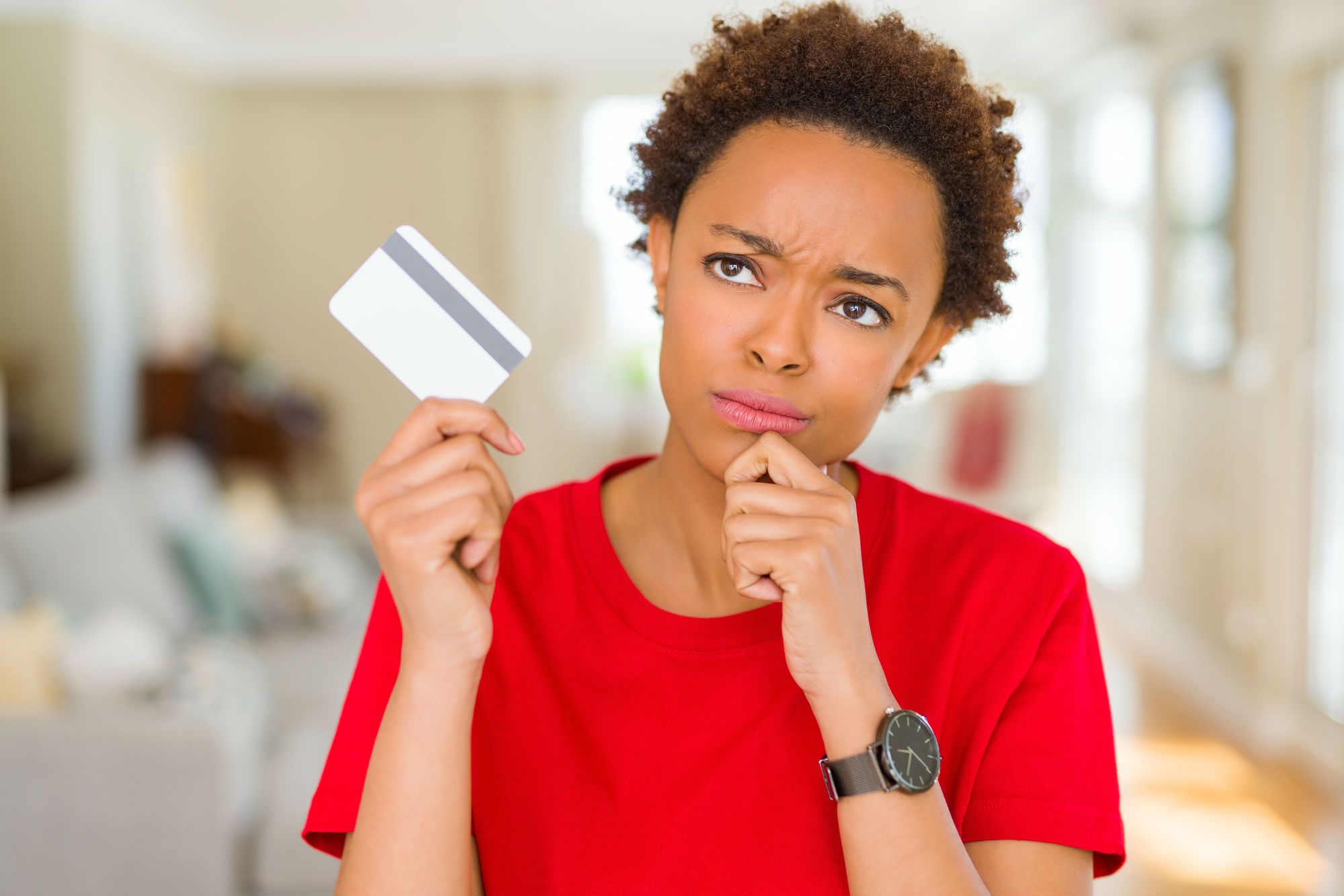 Concerned woman looking at credit card