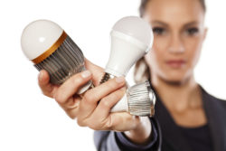 Woman holding LED bulbs wonders are Cree LEDs good