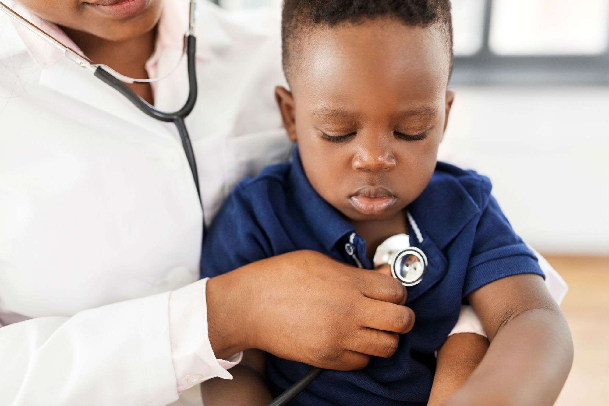 Baby being examined in clinic with stethoscope