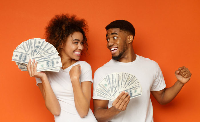 couple holding money from a conde nast settlement
