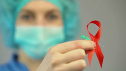 Doctor holding AIDS awareness ribbon
