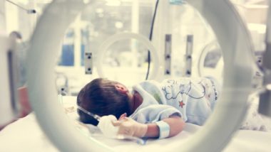 Newborn baby in incubator