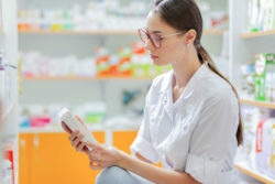 Pharmacist looking at antibiotic warning