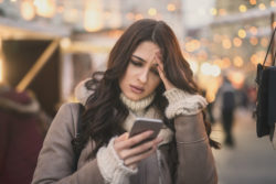 Woman annoyed by spam text messages