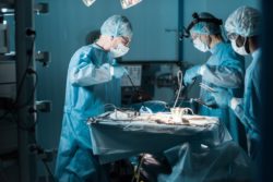Three surgeons operating
