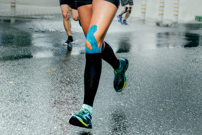 runner with rocktape on leg