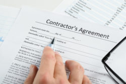 Close-up man signing contractor's agreement