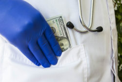 Doctor pockets hundred dollar bill