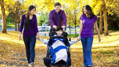 Family with disabled child walking